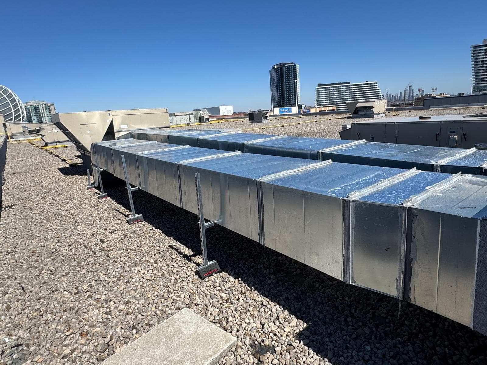 VentPro rooftop ductwork installation overlooking the city skyline